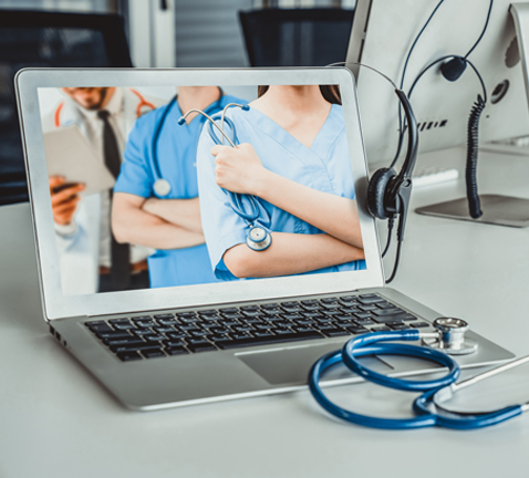 laptop screen showing individuals in the medical field